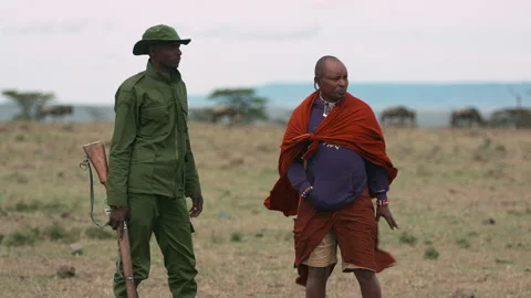 Maasai Warrior Elder and Game Ranger in Conversation Stock Footage 198510772