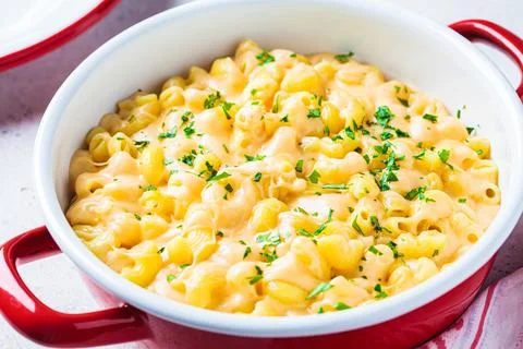 Mac and cheese in red pot. Traditional American food. Stock Photos