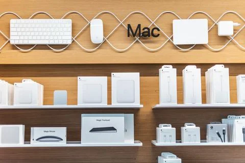 Mac Computers and Accessories on Organized Wooden Retail Shelves Stock Photos