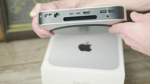 Mac Mini M1 Apple computer held in male hands, technology portability, work.. Stock Footage 305677980