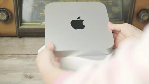 Mac Mini M1 Apple computer held in female hands, technology portability, wo.. Stock Footage 310639028