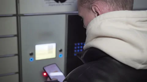 Mac scans QR Code on mobile smartphone and press buttons for collecting parcel Stock Footage 227345537