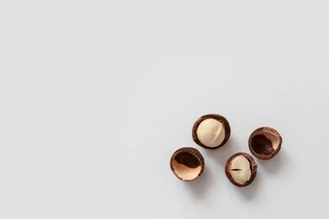Macadamia nut shells scattered on a gray background, top view, flat lay Foto stock