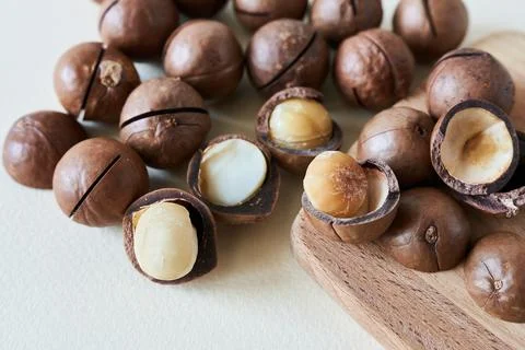 Macadamia nuts on a beige background. Healthy food. Super food. Stock Photos