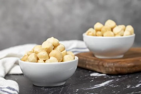 Macadamia nuts. Peeled Macadamia Nuts in a ceramic bowl. superfood. Vegetaria Stock Photos