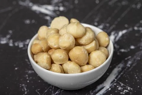 Macadamia nuts. Peeled Macadamia Nuts in a ceramic bowl. superfood. Vegetaria Stock Photos