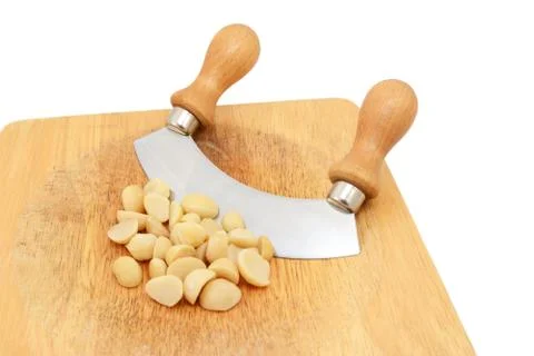 Macadamia nuts with a rocking knife Stock Photos