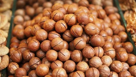 Macadamia nuts in shells displayed for sale at a market Stock Footage 348550587