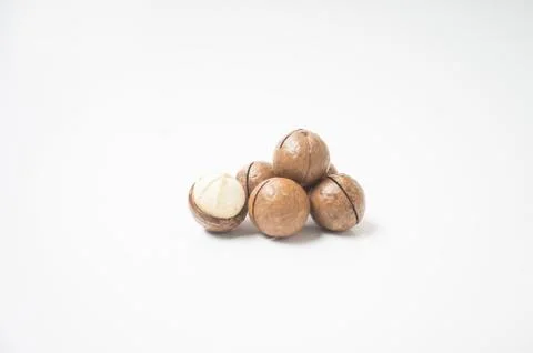 Macadamia nuts on white background. Stock Photos