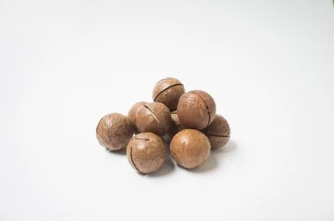 Macadamia nuts on white background. Stock Photos