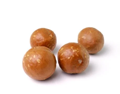 Macadamia nuts on white background Stock Photos