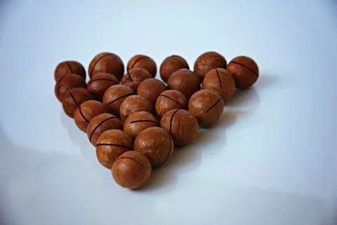 Macadamia nuts on a white surface Stock-Fotos