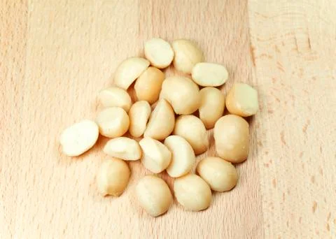 Macadamia nuts on wood table Stock Photos