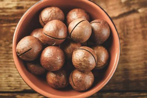 Macadamia nuts on wooden table Stock Photos