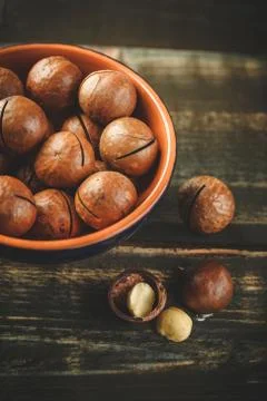 Macadamia nuts on wooden table Stock Photos