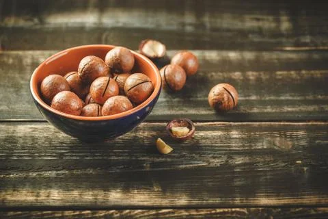Macadamia nuts on wooden table Stock Photos