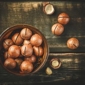 Macadamia nuts on wooden table Stock Photos