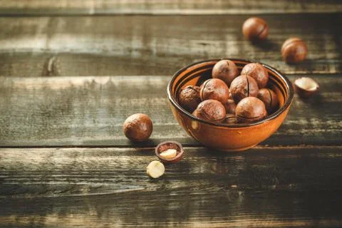 Macadamia nuts on wooden table Stock Photos