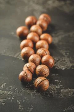 Macadamia nuts on wooden table Stock Photos
