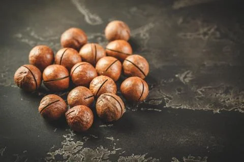 Macadamia nuts on wooden table Stock Photos