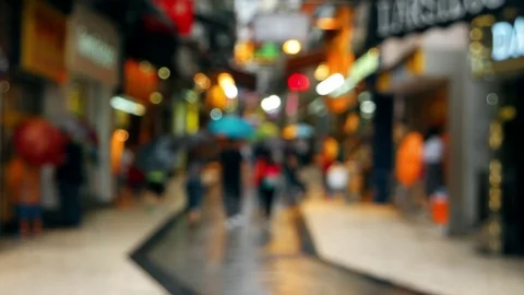 Macao - Defocused people with umbrellas walking in Historic Centre of Macao Stock Footage 70528622