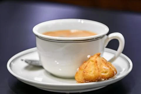 Macaron cookie and a cup of latte coffee at a bakery in Strasbou Stock Photos