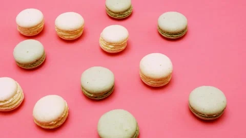Macaron cookies sliding on bright pink background in stop motion clip. Video stock 345112784