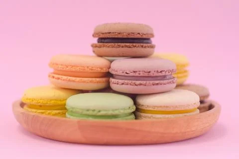 Macaron cookies stack together like triangle. on pink background. Stock Photos