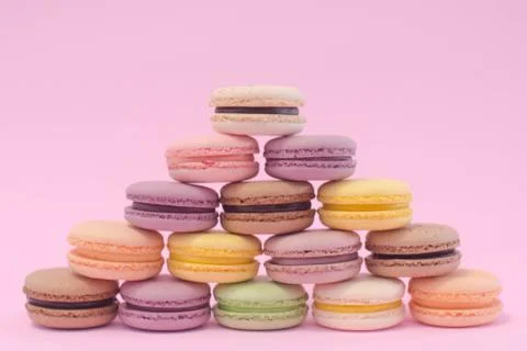 Macaron cookies stack together like triangle. on pink background. Stock Photos