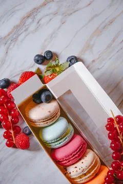 Macaron dessert, a box with colorful macarons lies on a marble style. Sweet.. 写真素材