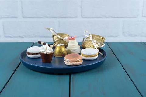 Macaron next to small chocolate cup with whipped cream, walnut cameo and truf Stock Photos