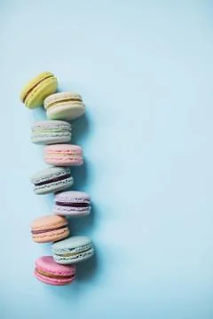 Macaron or macaroon biscuits on pastel blue background from above. Top view. Stock Photos