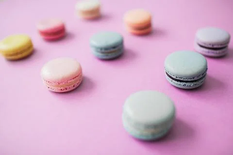 Macaron or macaroon biscuits on pastel pink background. Stock Photos