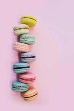 Macaron or macaroon biscuits on pastel pink background. Copy space. Stock Photos