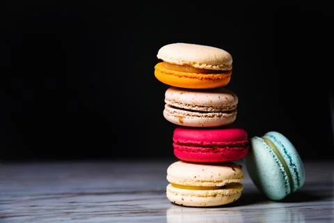 Macaron pink, orange and beige, blue on marble style and black background. .. Stock Photos