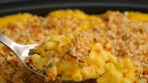 Macaroni and cheese. Spoon scooping through bubbling breadcrumb crust Stock Footage 102136071