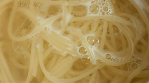 Macaroni and spaghetti are cooked in a pan Stock Footage 126749384