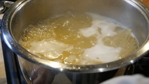 Macaroni is being boiled in a pot over a gas stove Stock-Footage 101546115