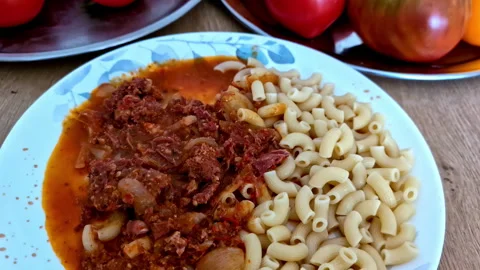 Macaroni with chilli tomato paste sauce, vegetable plants on plate Stock Footage 285437233