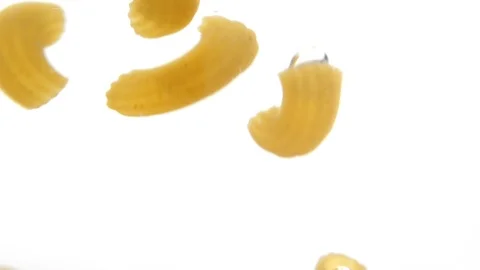 Macaroni falling into water in slow motion. Macaroni falling on white background Stock Footage 126330166