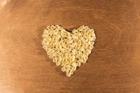 Macaroni is laid out in the form of a heart. Valentine's Day. Stock Photos
