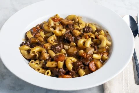 Macaroni  mixed with beef stew Stock Photos