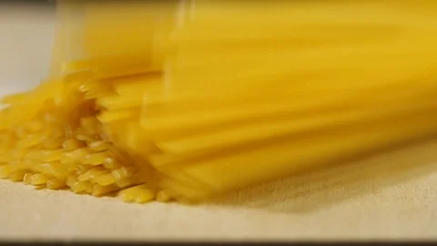 Macaroni pasta falling in slow motion on wooden Stock Footage 113594247