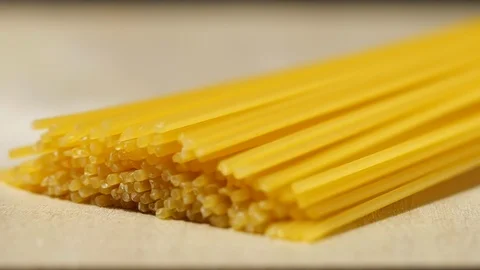 Macaroni pasta falling in slow motion on wooden Stock Footage 113594276