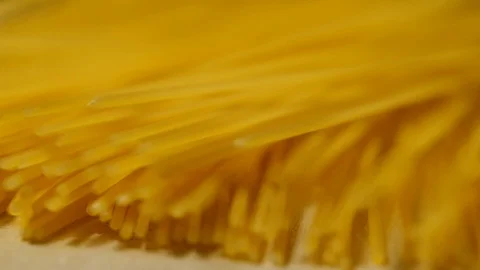 Macaroni pasta falling in slow motion on wooden Stock Footage 113594329