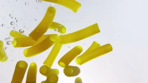 Macaroni pasta splash falling into boiled water, shot in slow motion on white Stock-Footage 76252360
