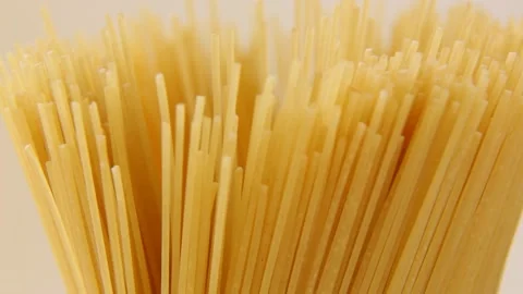 Macaroni raw long Italian close-up descend and rotate. Video stock 168600611