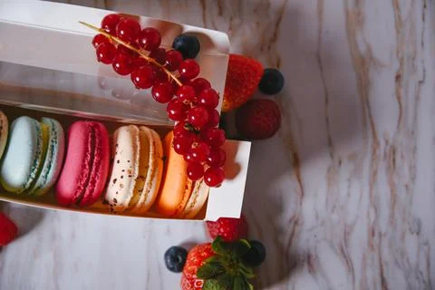 Macaronis in a white box with a transparent window. Color dessert, pink, mi.. Stock Photos