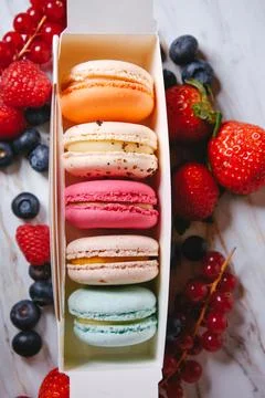 Macaronis in a white box with a transparent window. Color dessert, pink, mi.. Stock Photos