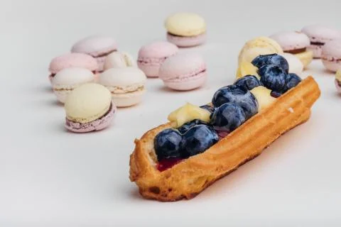 Macarons  and Brewed cake eclair Stock Photos